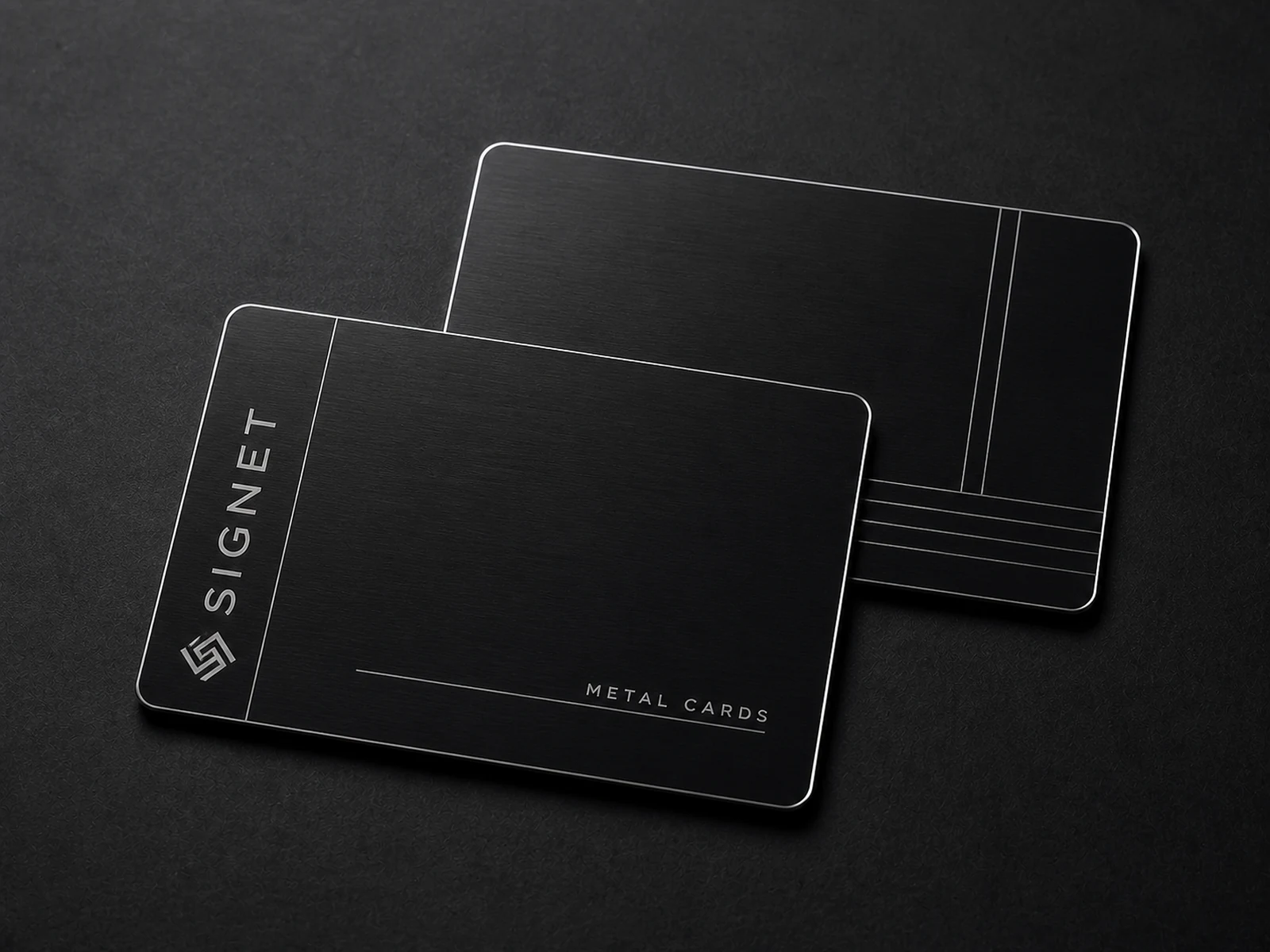 Two black stainless steel metal business cards with fine silver details