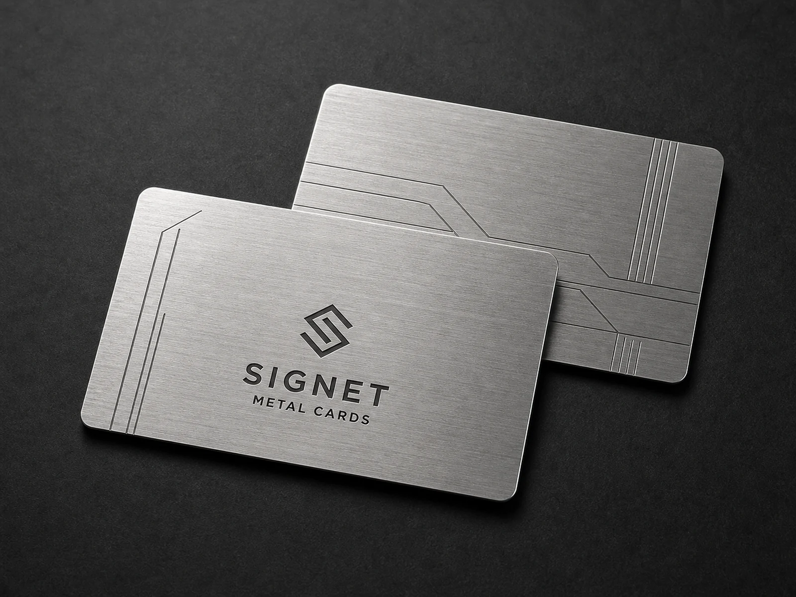 Two brushed stainless steel metal business cards with a silver directional finish