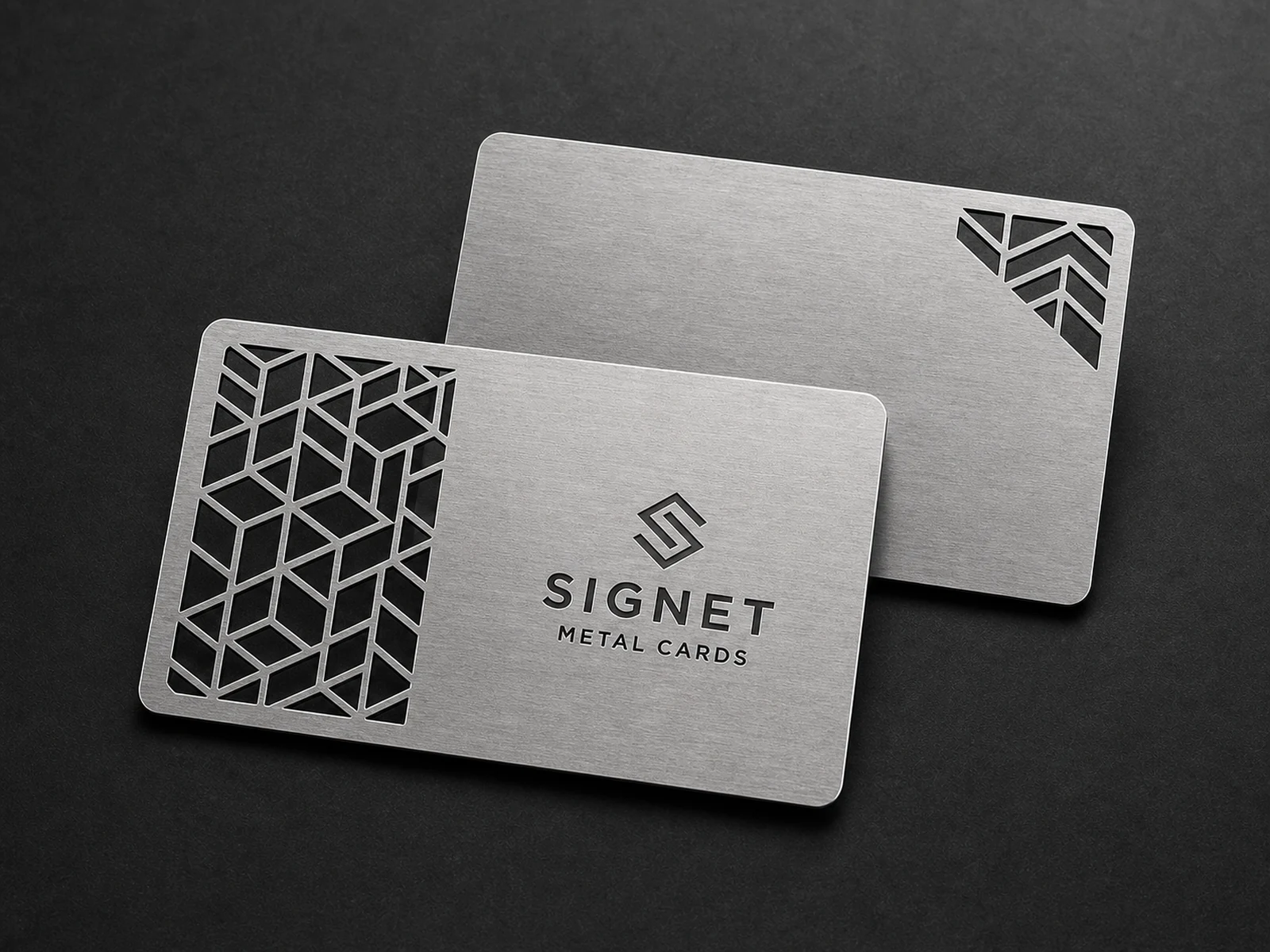 Two stainless steel metal business cards with structurally connected geometric cutouts